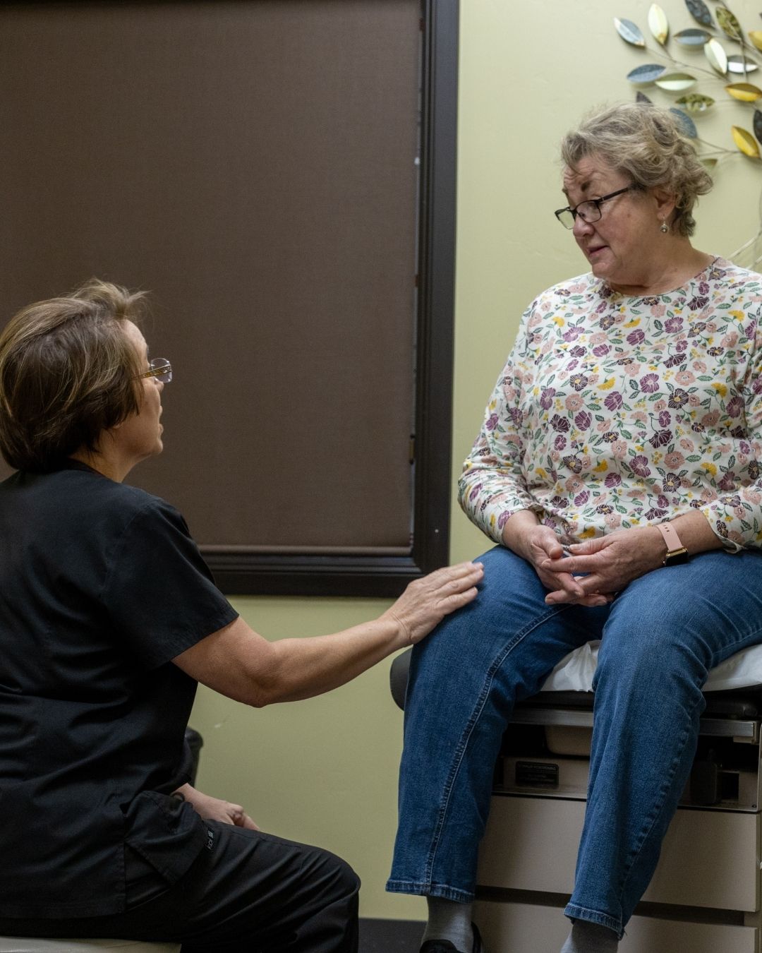 pic-womenshealth-rm Female healthcare provider consulting with a patient in a medical office, emphasizing women's health services and compassionate care.