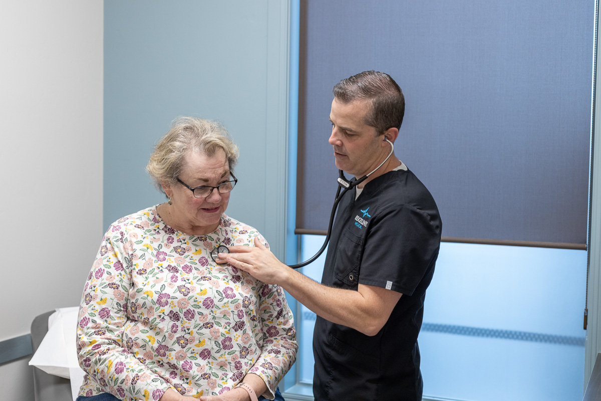 woman getting exam with male provider at clinic